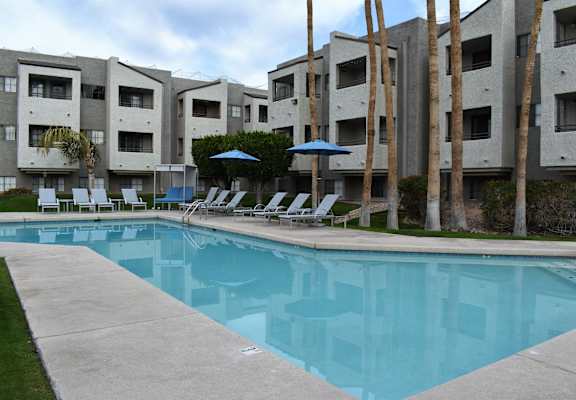 a large pool in front of an apartment building
