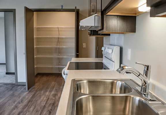 a kitchen with a sink and a washer and dryer