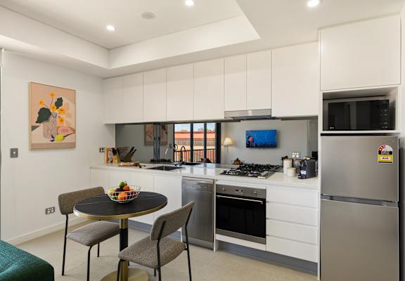 A modern kitchen with a table and chairs.
