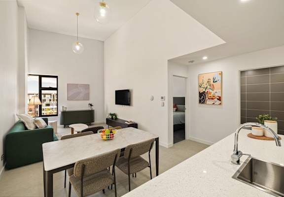 A modern kitchen with a dining table and chairs.