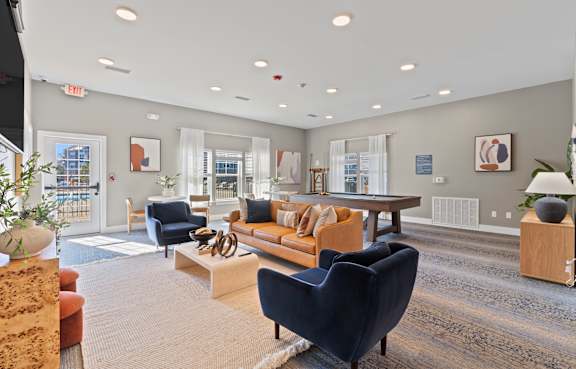 A spacious living room with a variety of furniture and decor.