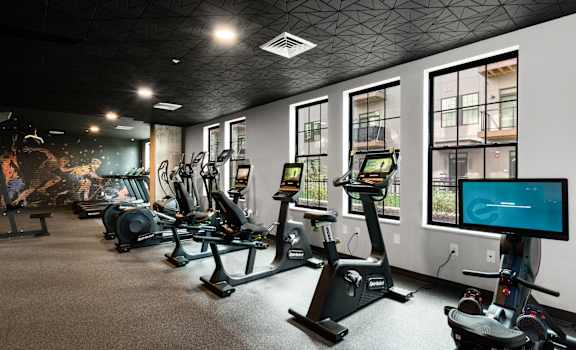 a gym with treadmills and other exercise equipment