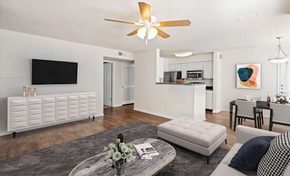a living room with white walls and a ceiling fan at Stonebriar Woods Apartments, Overland Park, KS