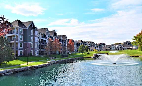 a pond with a fountain in front of a building  at Waterside Residences on Quivira, Lenexa, KS, 66215