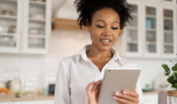 woman using a tablet computer in the kitchen