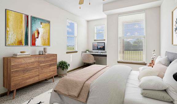 A bedroom with a bed, dresser, and a ceiling fan.