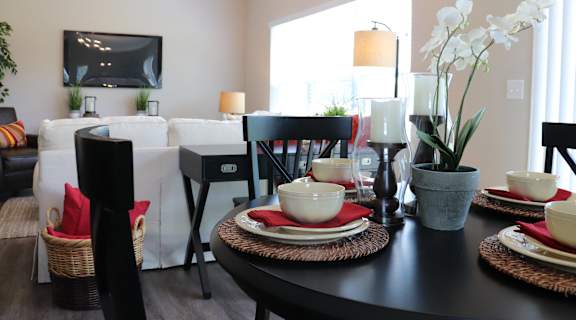 a living room and dining room with a table and chairs