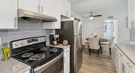 a kitchen with stainless steel appliances and white cabinets