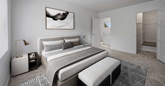 A modern bedroom with a large bed and a painting on the wall.