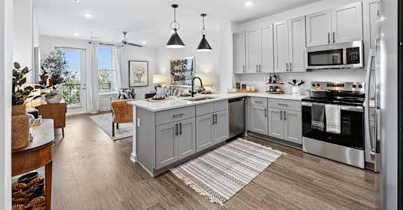 A modern kitchen with a large island and stainless steel appliances.
