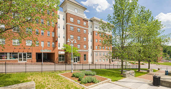 a large brick building with a clock on the side of it