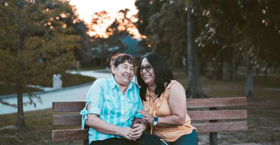 a couple sitting on a park bench
