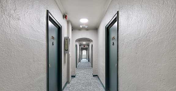 A long hallway with doors on both sides.