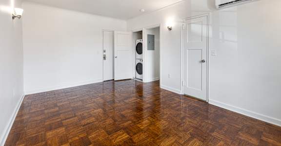 A room with a wooden floor and white walls.