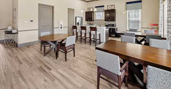 Summerset Affordable Apartments A modern kitchen with a dining table and chairs.