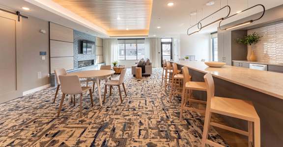 a dining room with tables and chairs and a kitchen
