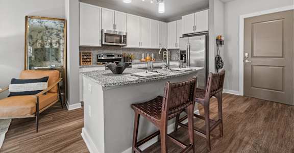 A kitchen with a counter and chairs. at 1010 Dilworth Apartments, Charlotte, North Carolina