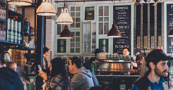 people sitting at tables in a restaurant