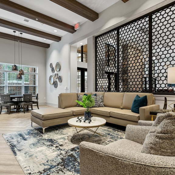 a living room with blue couches and chairs and a fireplace