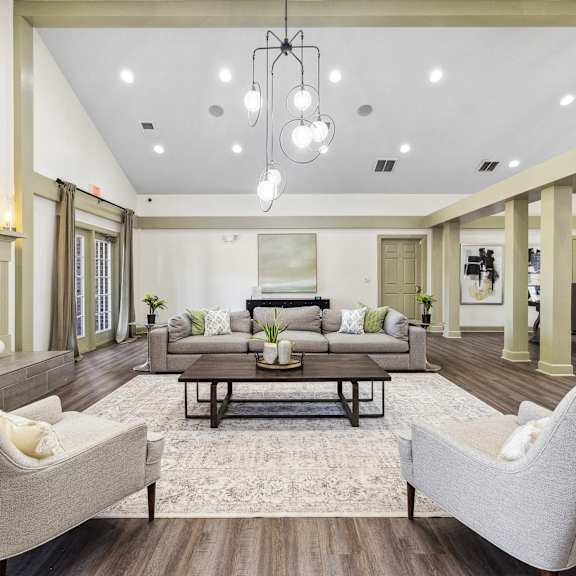a living room with blue couches and chairs and a fireplace