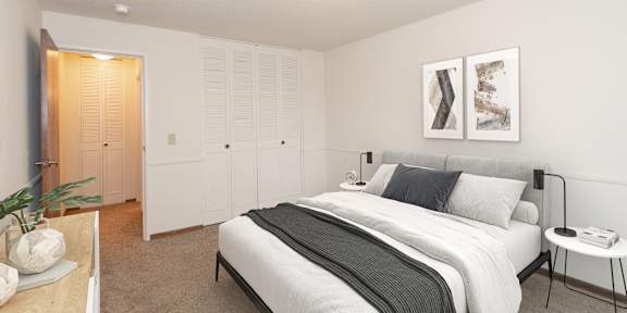 A bedroom with a white bed and a giraffe toy.