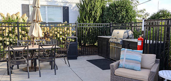 a patio with a table and chairs and an umbrella