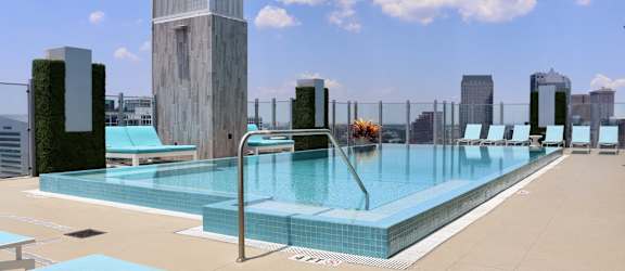 a swimming pool on the rooftop of a building in a city