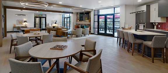 A modern dining room with a large table and chairs.