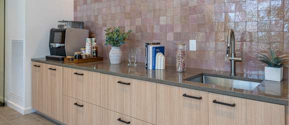 A kitchen with wooden cabinets and a tiled backsplash.