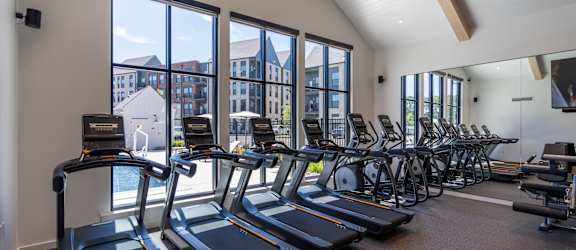 A gym with treadmills and exercise bikes.