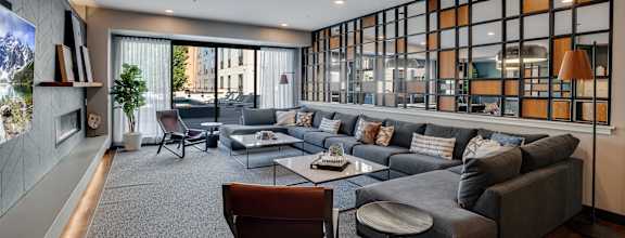 A modern living room with a grey sofa and a wooden coffee table.