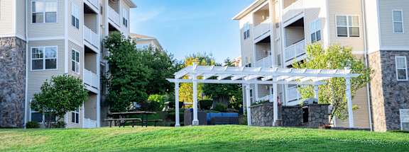 an image of an apartment building with a lawn