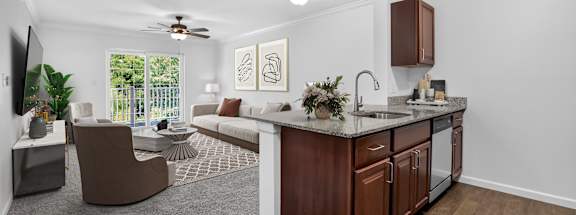 A modern kitchen with dark wood cabinets and a white countertop.