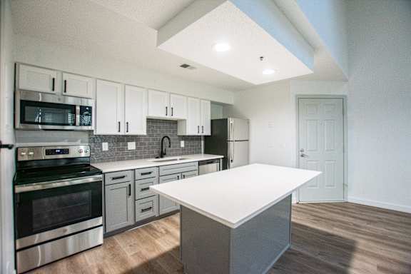 A modern kitchen with a large island in the middle.