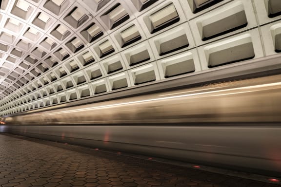 a subway train speeding through a subway station