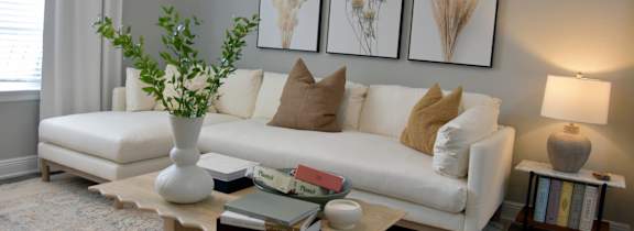 a living room with a white couch and a table