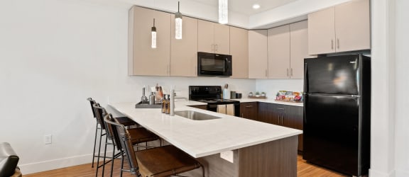 a kitchen with a long island with a white countertop