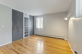 a living room with grey walls and hardwood floors