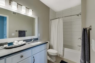 Spacious bathroom with tub, shower and quartz countertops in 2 bedroom apartment for rent at Ascend at Woodbury best new apartments Woodbury MN 55129