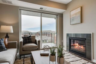 Living room with a fireplace of 2 bedroom apartment for rent at Ascend at Woodbury best apartments Woodbury MN 55129