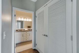 View into bathroom and closet space at Ascend at Woodbury luxury apartments