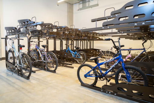 a rack of bikes in a room with other bikes on racks