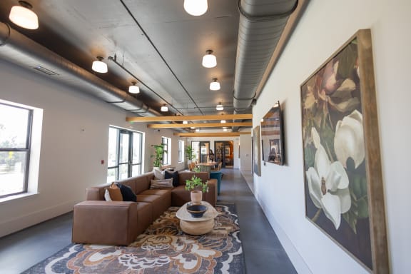 A long hallway with a brown couch and a painting on the wall. at La Unión, Tampa, 33605