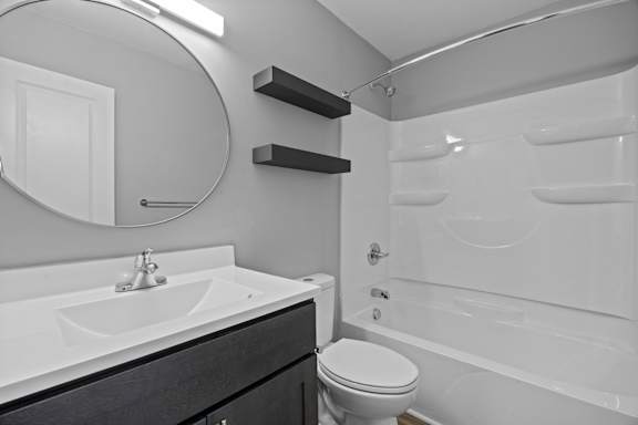 A white bathroom with a toilet, sink, and bathtub.
