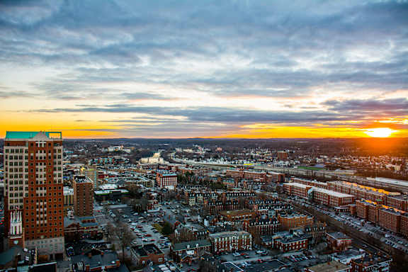 A cityscape with a sunset in the background.