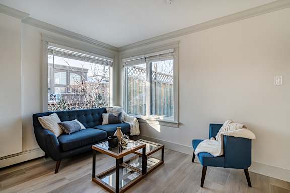 A living room with a blue couch and a coffee table.