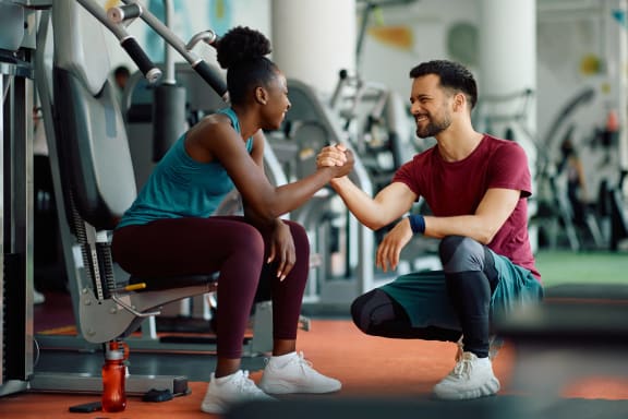 a man and a woman shaking hands in a gym at The Sutton, Atlanta, Georgia