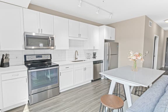 a kitchen with stainless steel appliances and white cabinets