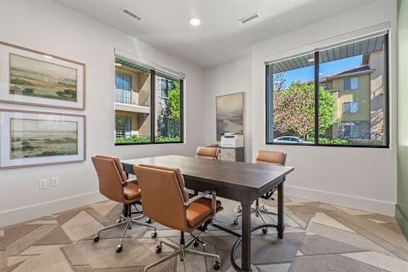 A conference room with a table and chairs.