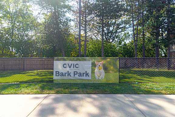 a sign for cvc bark park with a dog on it at AVIA Lofts on Victors Way, Michigan, 48108